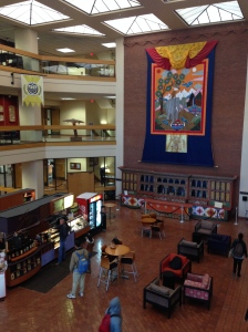 Campus library: A giant thangkha of the Four Friends hangs over a 100-foot altar in the lobby.  At the espresso stand on the left, the barista told me the architecture is even starting to seep into other places around El Paso
